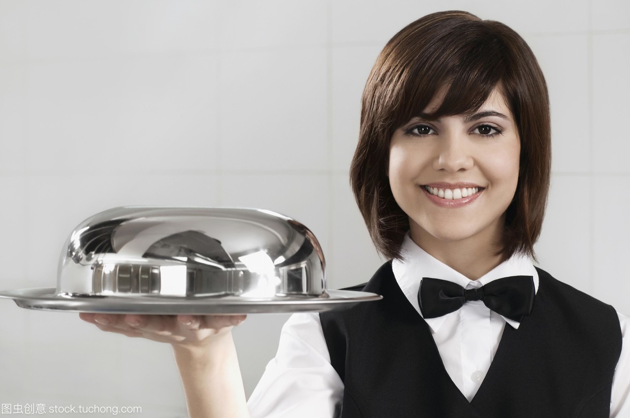 服務(wù)員拿著一個圓頂?shù)谋P子